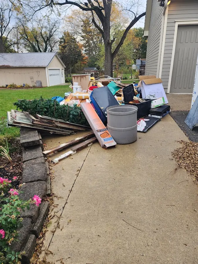 Dumpster being loaded with debris for 12 Yard Dumpster Rental in Beach City